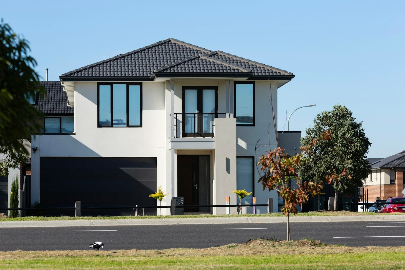 Two-story house with a wide dark sectional garage door